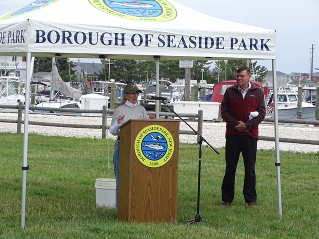 A podium is positioned in front of a tent